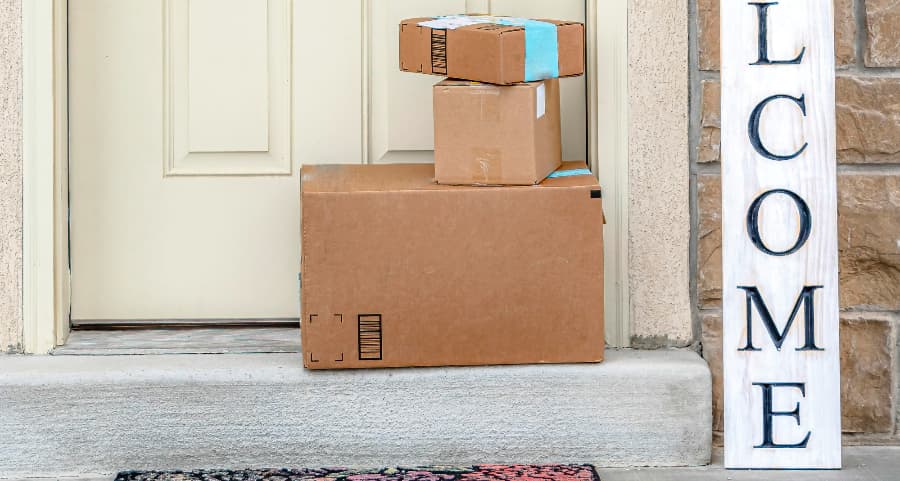 Packages on the doorstep of a home with a welcome sign in Roanoke